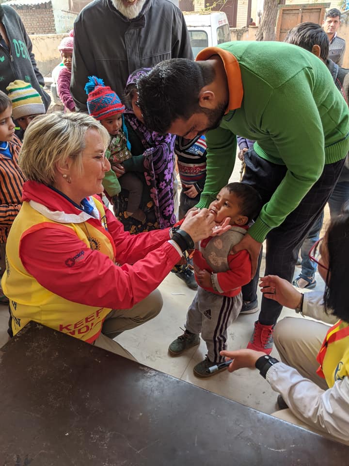 Kim Bramlage administers a vaccine during an international service mission.
