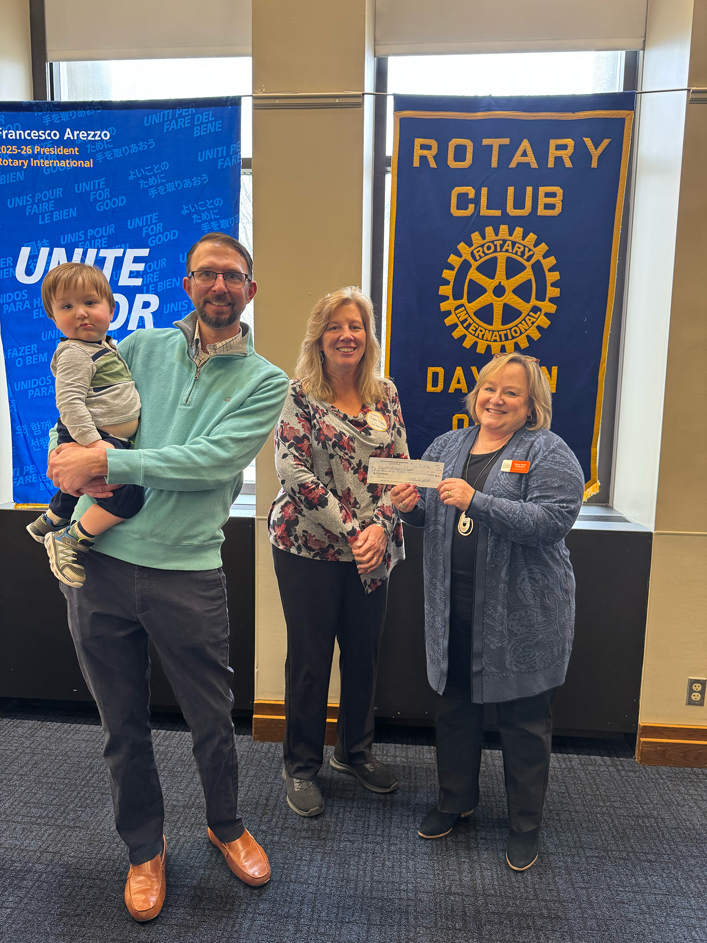 Trustee Scott Kayser presents a $3,000 Impact Grant to Dayton Diaper Depot, represented by Mary Beth Thomas and organization founder Maggie Schneemann. They are joined by Scott's diaper-clad son, Harrison.