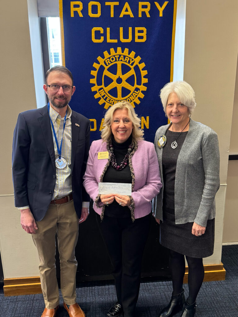 Dana Lynch and Rotarian Judy Budi accept a $3,000 Impact Grant on behalf of Graceworks. Trustee Scott Kayser presented the grant on behalf of the foundation.